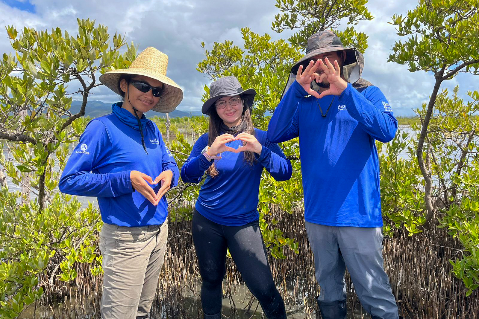 Nicole Pillot (center) with other BoriCorps members standing in the mangrove forest. (Photo: Jobos Bay National Estuarine Research Reserve)