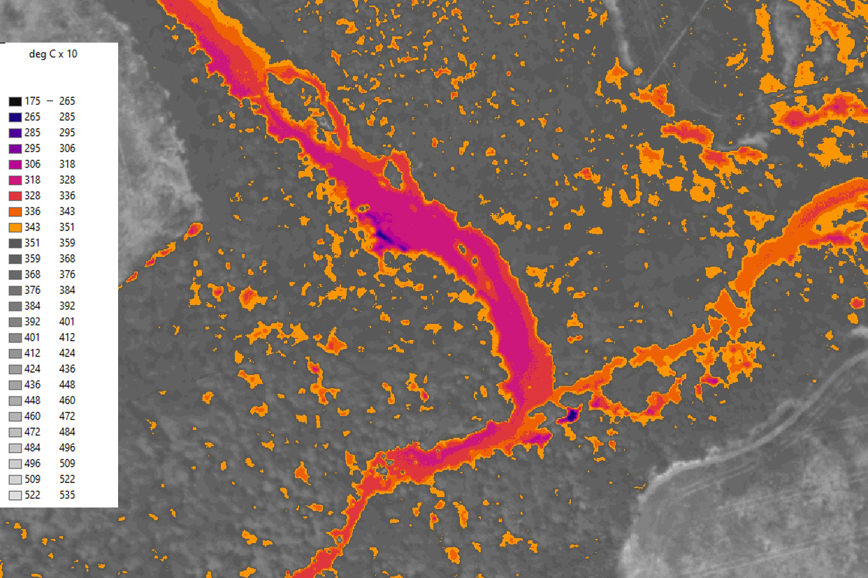  At top the aerial photo of the river, nested within a heavily forested area. Beneath is a thermal image capturing surface temperatures using infrared imaging. Much of the river is in bright reds, oranges, and pinks with a few dark blue patches of colder water.