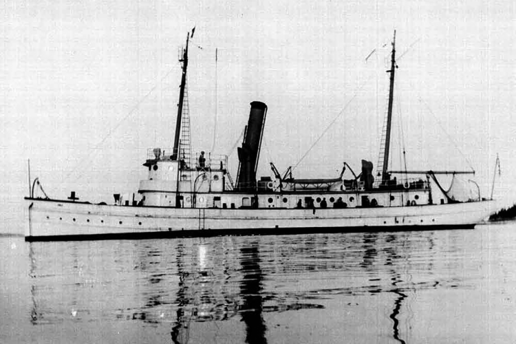 The steamer sail Albatross II, with reflection in water.
