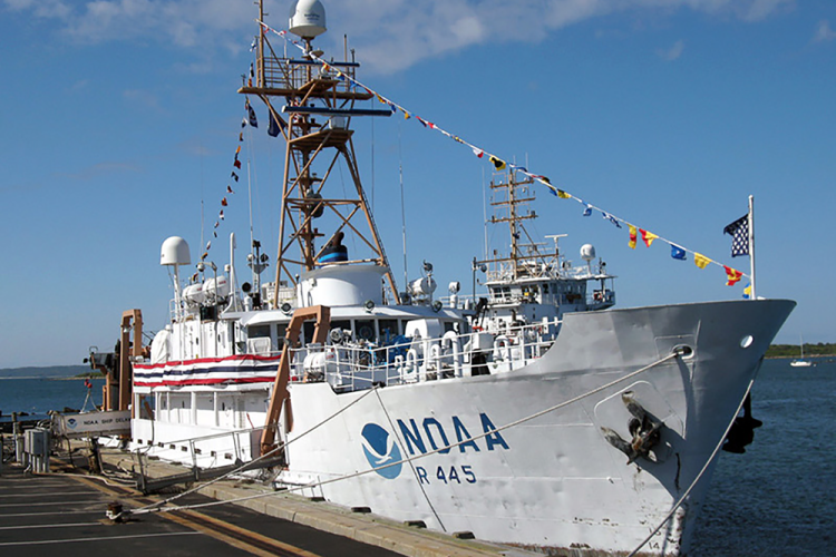 NOAA white boat, the Delaware II with celebration banners and flags tied to the dock.