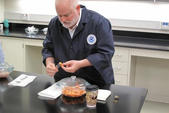 Steve Wilson, Director of NOAA Fisheries' Seafood Inspection Program, analyzes a shrimp sample at NOAA's National Seafood Inspection Lab in Pascagoula, Mississippi.