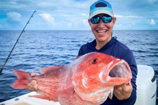 Recreational angler holds up a red snapper caught in the Gulf of Mexico
