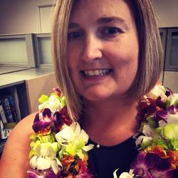Jennifer McCullough adorned with two colorful orchid leis.