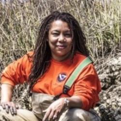 Female scientist working in an oyster reef.