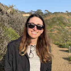 Kara standing in foreground with nature scene behind