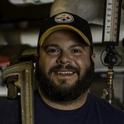 Domenick Capomolla holding wrench.