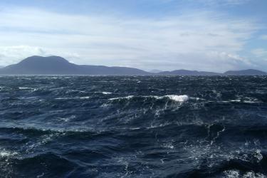 Photo of white capped waves off the coast of Alaska.