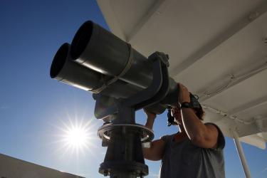 Person looking through binoculars