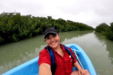 Elena Flores sitting in a kayak visiting mangrove sites in Tamaulipas, Mexico.  