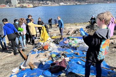 Children on the beach in Juneau collecting marine debris 