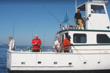 Five recreational anglers fishing on a boat