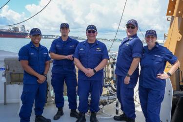 Five of the Oregon II's NOAA Commission Corps Officers standing together on the stern of the ship.