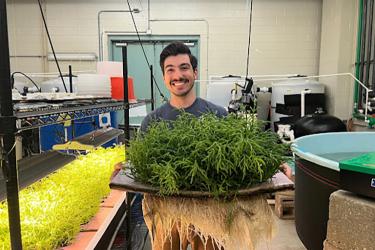 Scientist holding tray of sea beans.