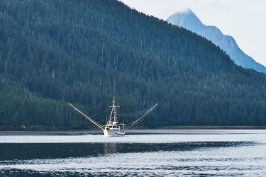 Salmon fishing troller in Southeast Alaska on a calm summer day.