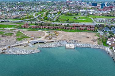 Aerial view of construction along a shoreline in an urban park