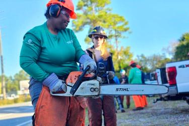 Alexis Powell with a chainsaw. Credit: Alexis Powell