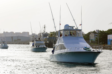 Three recreational fishing boats returning to the marina
