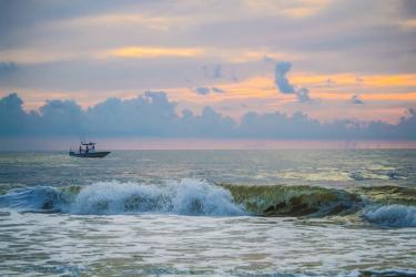 Private sport fishing boat just off the Florida coast at sunrise.