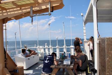 Crew members enjoying time off on the flying bridge of the R/V Gordon Gunter.