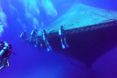 divers around the open-ocean aquaculture cage at the Cape Eleuthera Institute at Cape Eleuthera in the Bahamas.