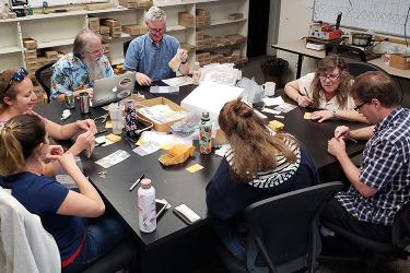 Scientist around table with assorted otolith samples and boxes. 