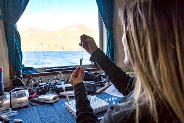 Scientist with sample in hands while on a boat