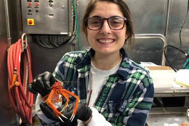 Victoria Salome holding a squat lobster.