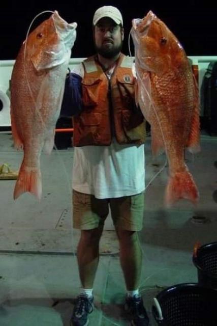 Walter holding two large red snapper retrieved on the Bottom Longline Survey on the Oregon II