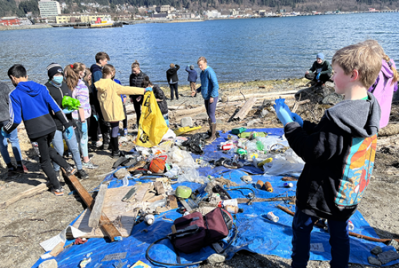 Children on the beach in Juneau collecting marine debris 