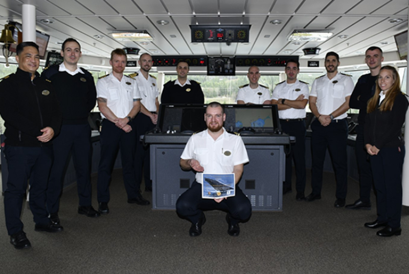 Bridge crew from Norwegian Encore holding their Certificate of Corporate Responsibility from the Whale Alert Alaska Program.