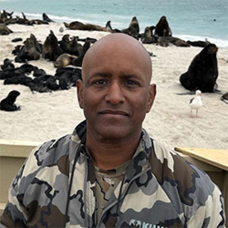 Portrait of a scientist on a beach with seals and sea lions