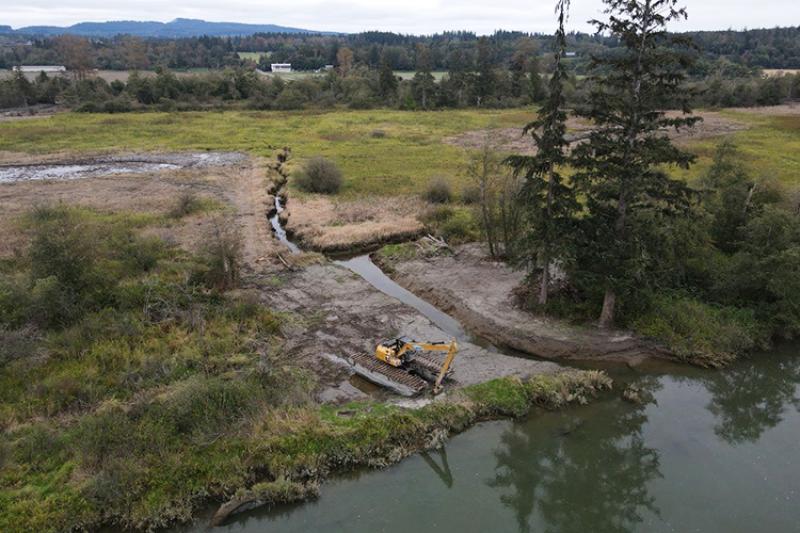 Aerial view of heavy machinery along a river