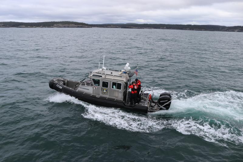NOAA Office of Law Enforcement officers and U.S. Coast Guard officers conduct a patrol on a NOAA enforcement vessel.