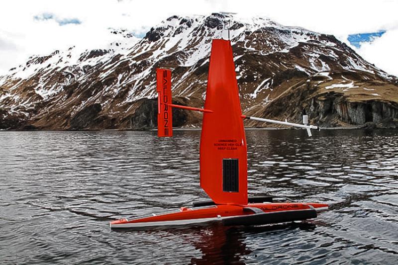 Sail drone in water with mountains in background.