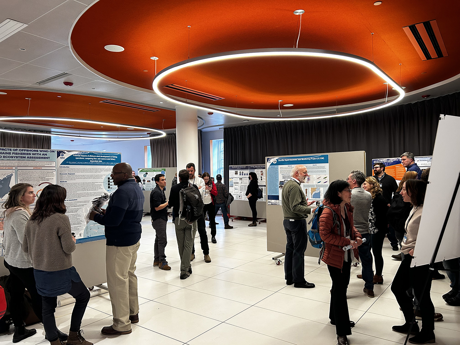 Summit participants in front of posters at the summit 2023.