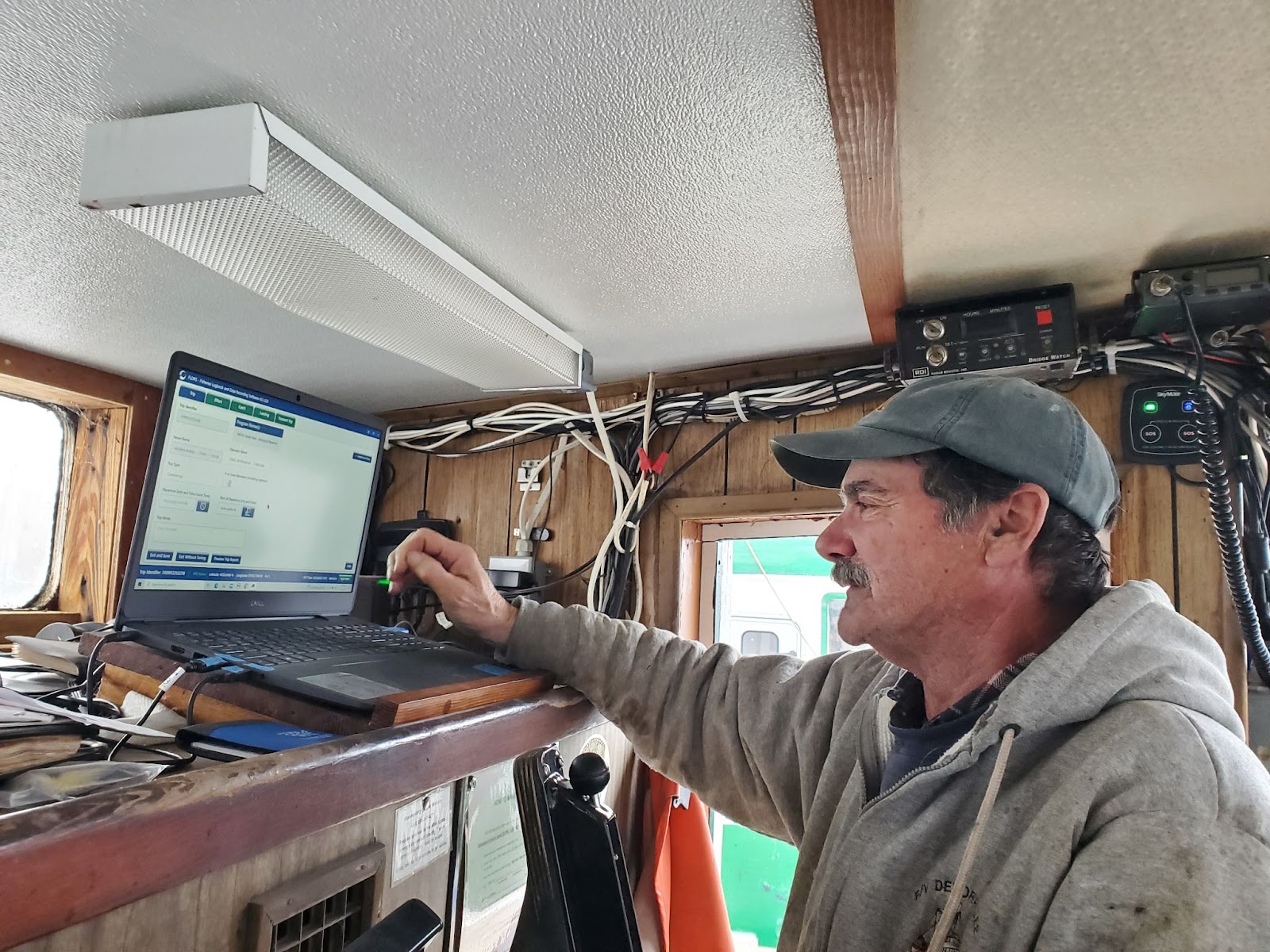 Captain Rodman in the wheelhouse uploading data.