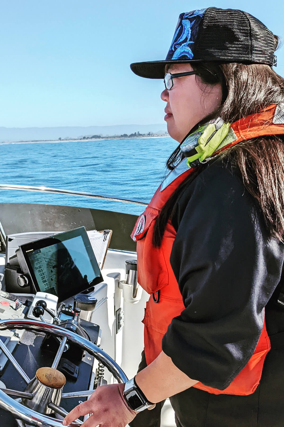 Stephanie Marcos aboard a vessel looking out to sea