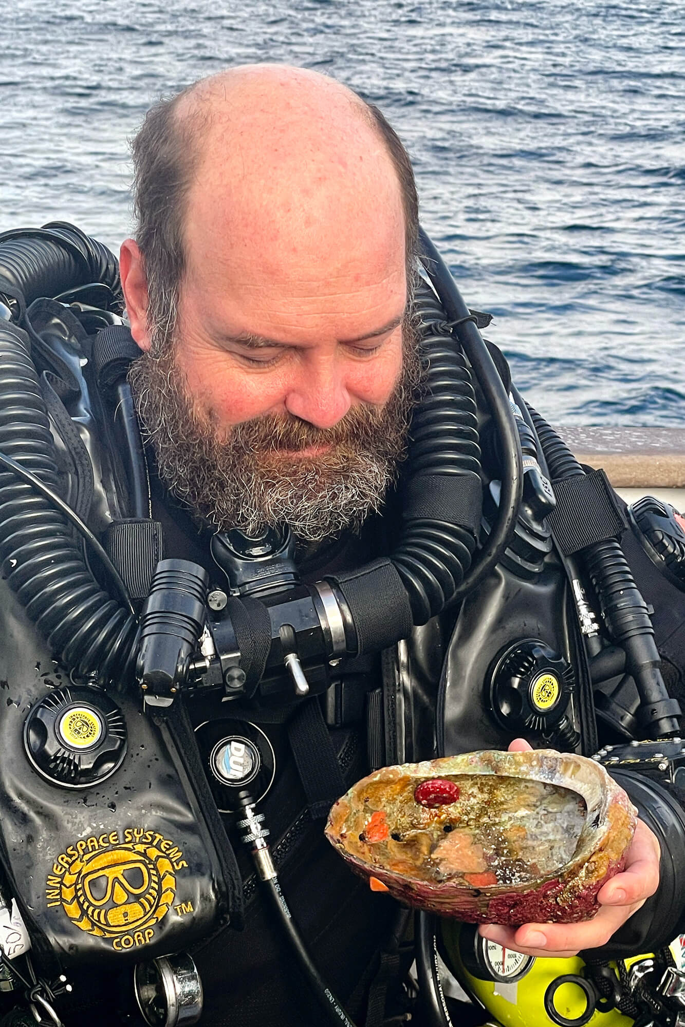 Joe Hoyt in diving gear holding an abalone shell