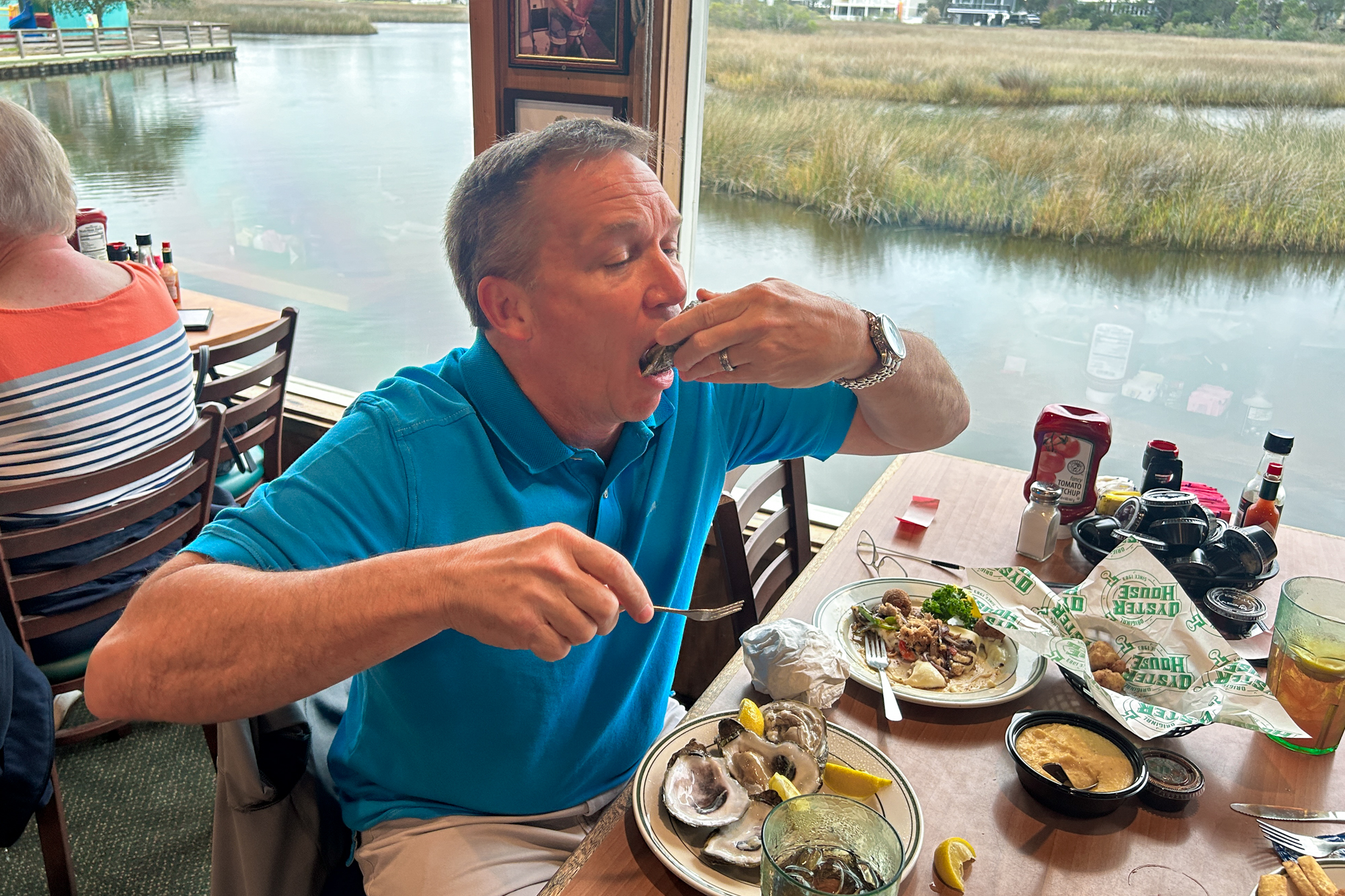Jeremy Sullivan of Orange Beach, Alabama, enjoys oysters on the half shell at the Original Oyster House in Gulf Shores, Alabama. (Photo: Original Oyster House)