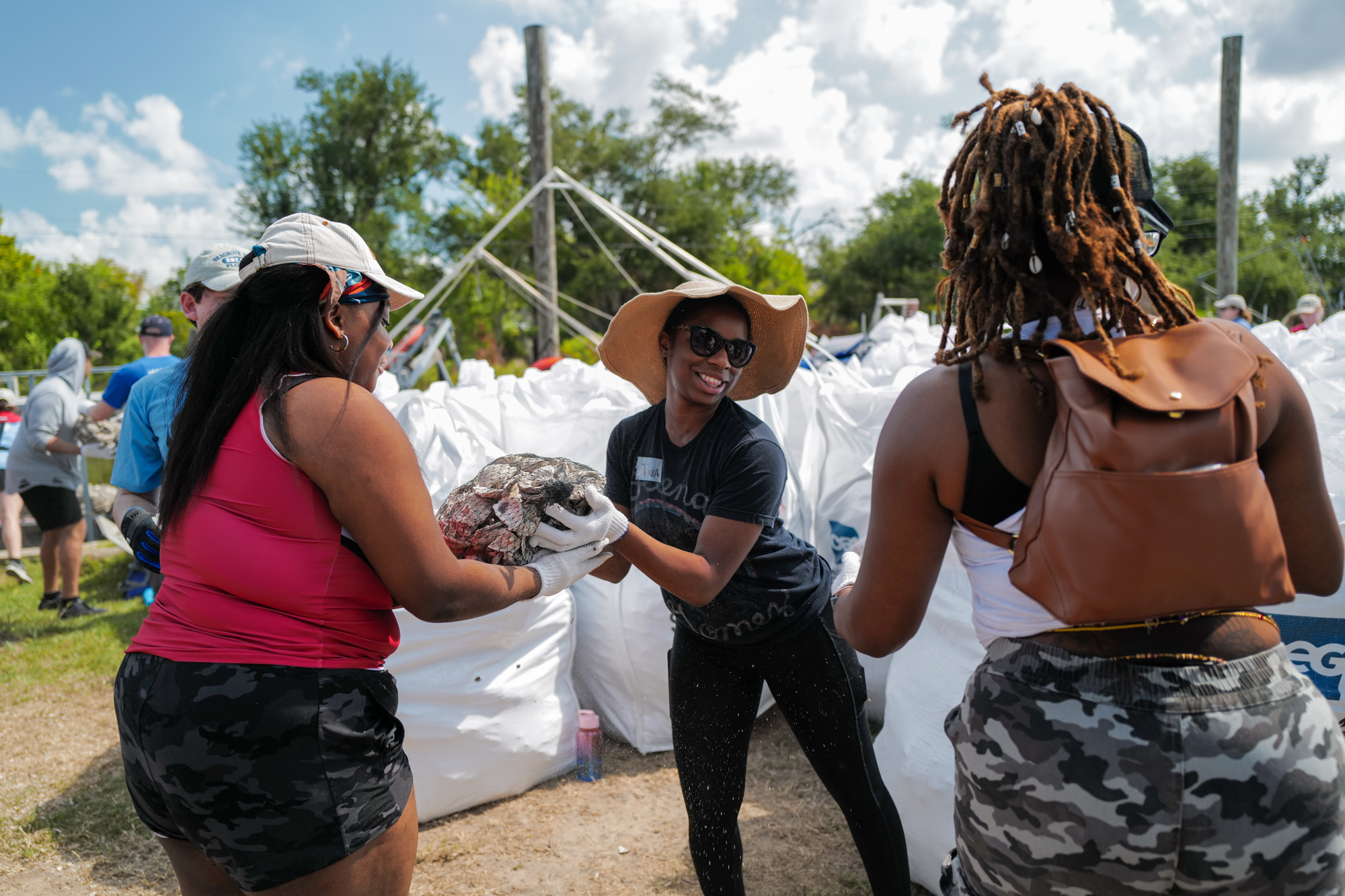 Volunteers gather bags of oyster shells to help protect ancient burial mounds belonging to the Pointe-au-Chien Tribe. (Photo: Coalition to Restore Coastal Louisiana)
