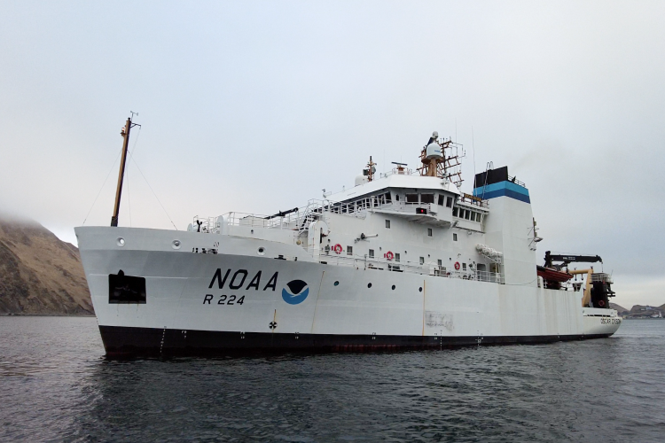 The research vessel Oscar Dyson, a large white boat with the NOAA logo on the side. Credit: NOAA Fisheries