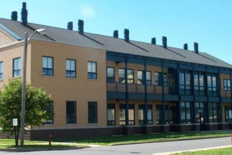 Yellow brick building with glass front, part of the laboratory complex.