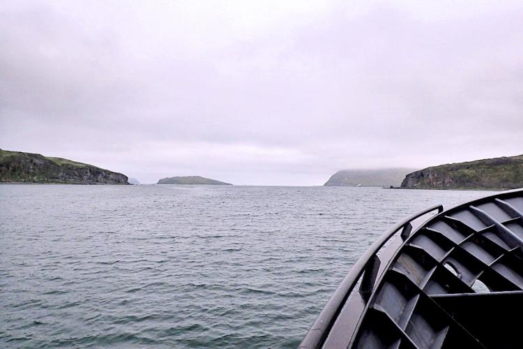 View from boat on water with islands in distance.