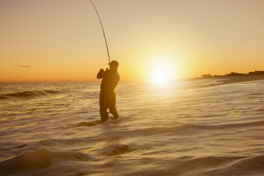 Surfaster in waves at sunrise.