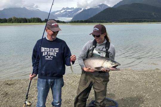 Father and daughter holding catch salmon catch