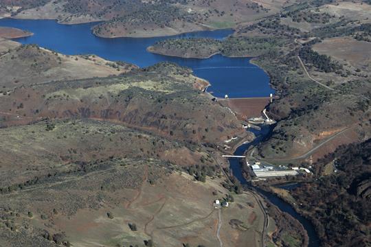 Aerial view of a large dam and reservoir