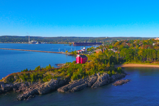 Red light house sits on island in Great Lakes