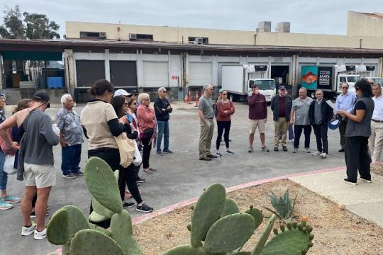 MAFAC members outside of Santa Monica Seafood hearing a talk from Sarah Shoffler (National Seafood Strategy Coordinator, NOAA Fisheries). 