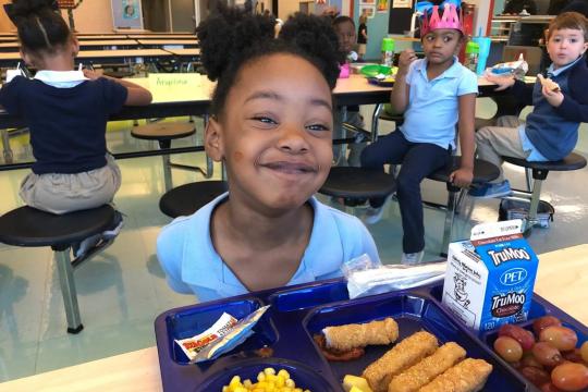 Seafood on a lunch tray with a student from a Greenville County school