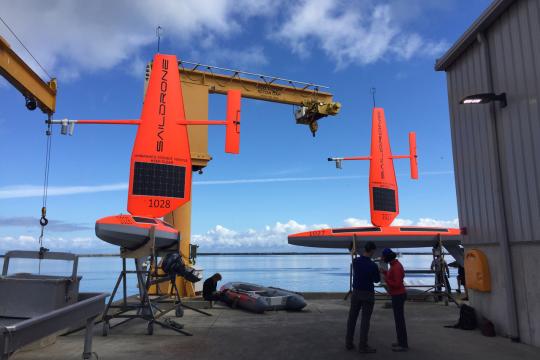 Technicians prepare the first two Saildrones for launch from Neah Bay, Washington.  Credit: NOAA Fisheries